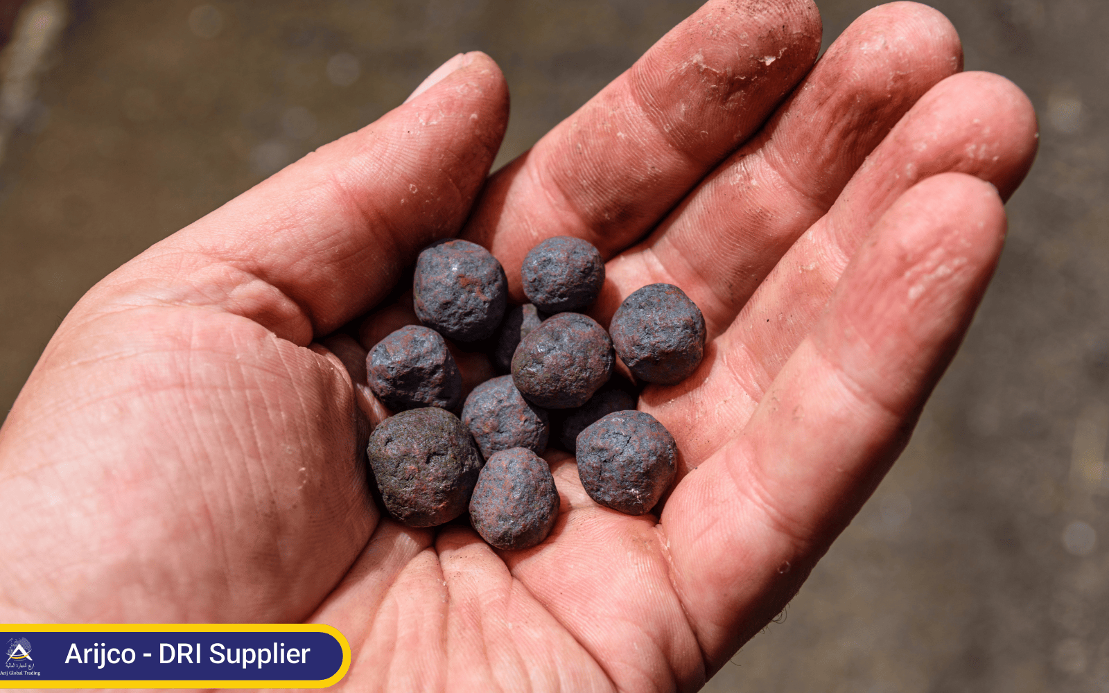 Hand holding premium-grade DRI pellets for steel production. High-Quality DRI Pellets from a Trusted DRI Supplier