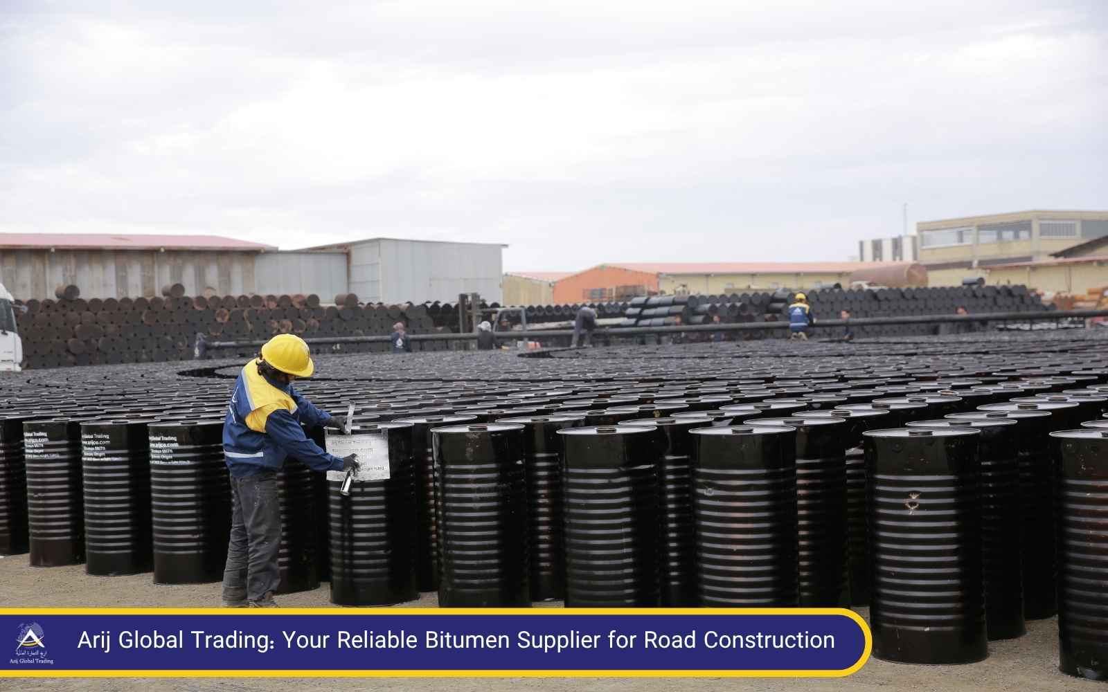 Quality-Controlled Bitumen for Road Construction by Trusted Bitumen Supplier Worker labeling drums of bitumen for export, showcasing Arij Global Trading's commitment as a reliable bitumen supplier for road construction