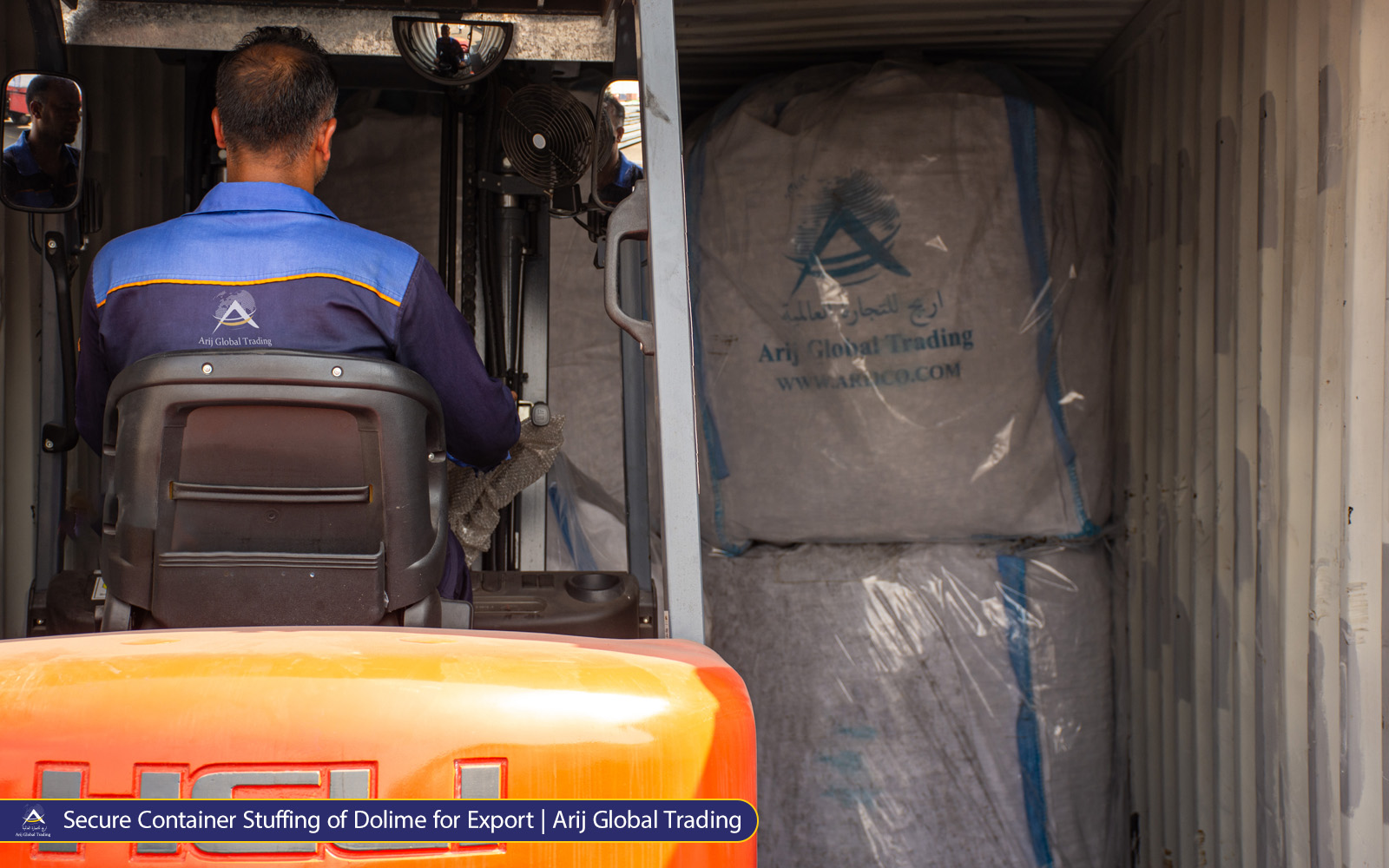Secure Container Stuffing of Dolime for Export A forklift lifting a heavy-duty jumbo bag of High-Purity Calcined Dolomite branded with the Arijco Global Trading logo at a port yard, ready for export to South Asian steel mills.