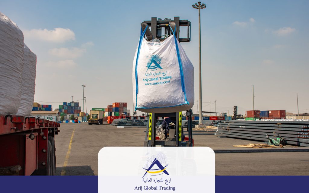 A forklift lifting a heavy-duty jumbo bag of High-Purity Calcined Dolomite branded with the Arijco Global Trading logo at a port yard, ready for export to South Asian steel mills.