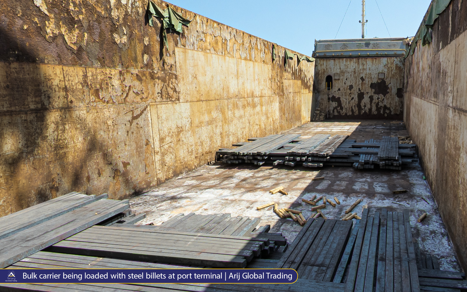 Bulk carrier cargo hold by Arijco being loaded with steel billets at port terminal for international export shipment