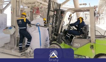 Arijco Industrial workers loading bulk material into jumbo bag using forklift in manufacturing plant with automated filling system