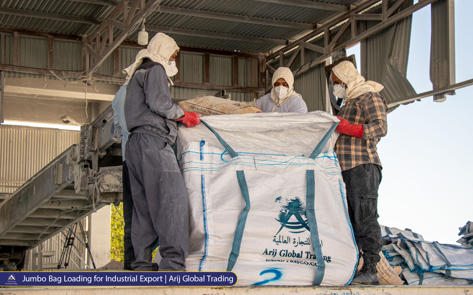 Jumbo Bag Loading for Industrial Export 02 Logistics team at Arijco Trading loading 50 KG white cement bags into a large jumbo sling bag for bulk vessel shipment to South Asian ports.