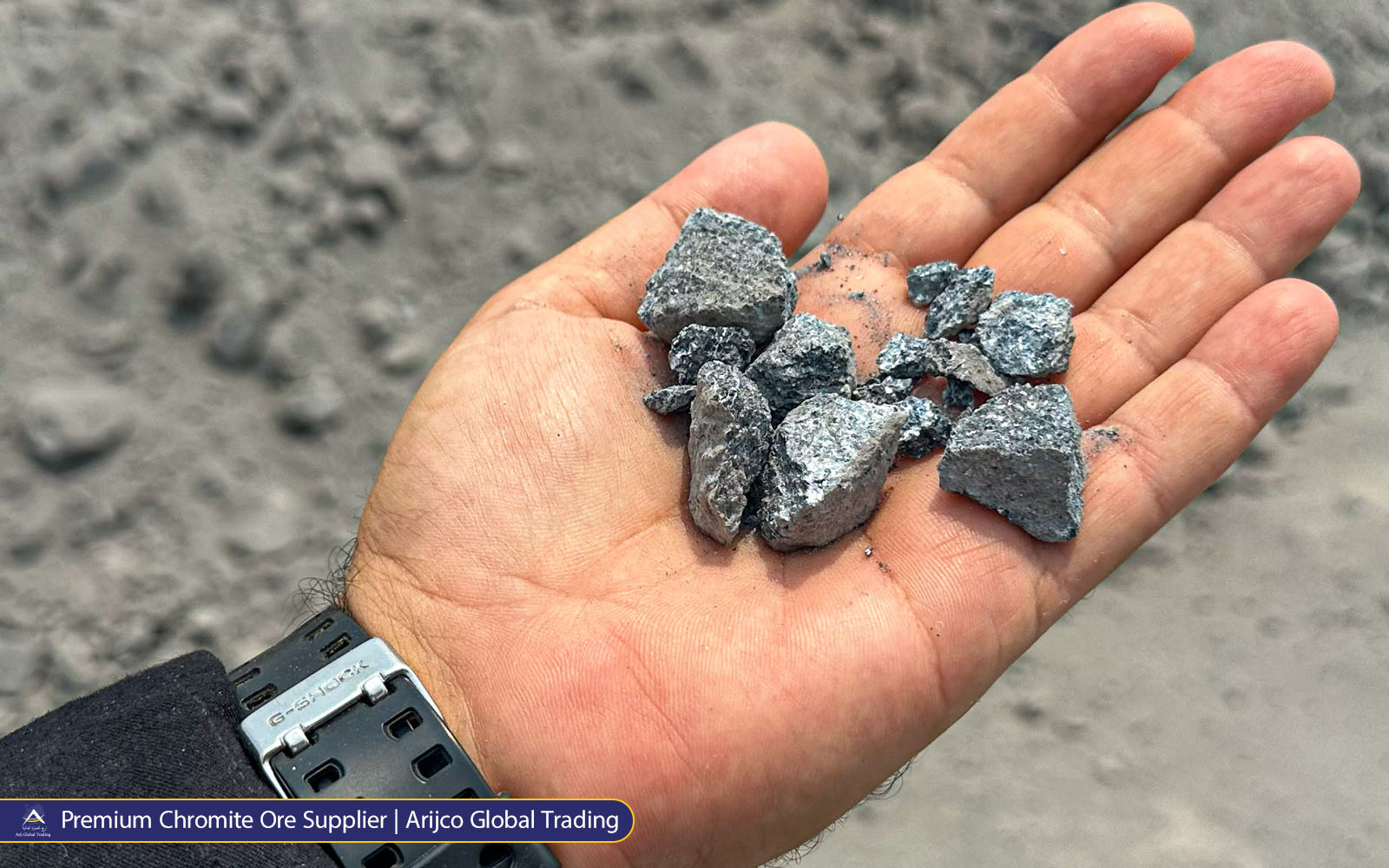 Close-up of Primmum chromite ore stones in hand at Arijco Global Trading mining and mineral supply site
