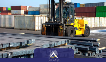 Heavy-duty forklift transporting steel billets at a global shipping port, surrounded by stacked containers. Arij Global Trading steel logistics operations.