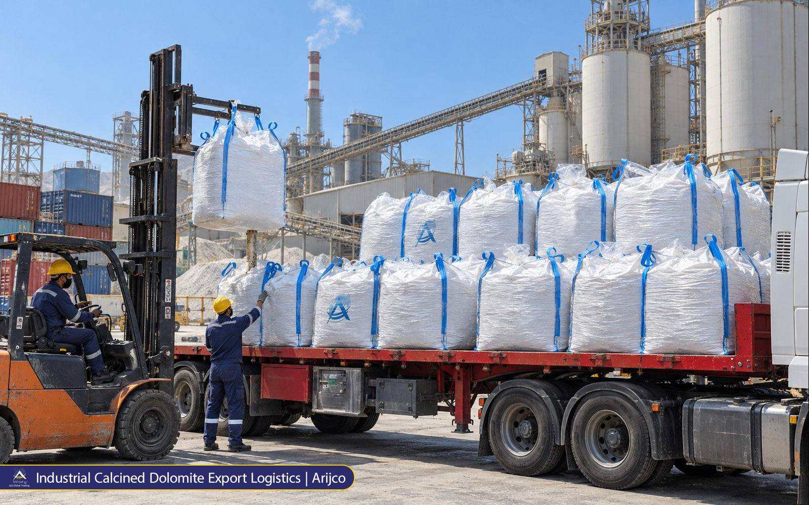 Industrial workers and forklift coordinating jumbo bag loading on a flatbed truck beside a mineral processing plant.